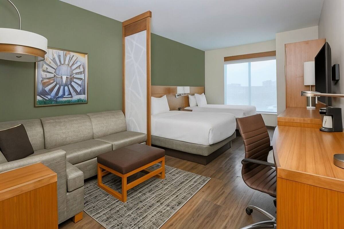 Premium bedding, desk, laptop workspace, blackout drapes