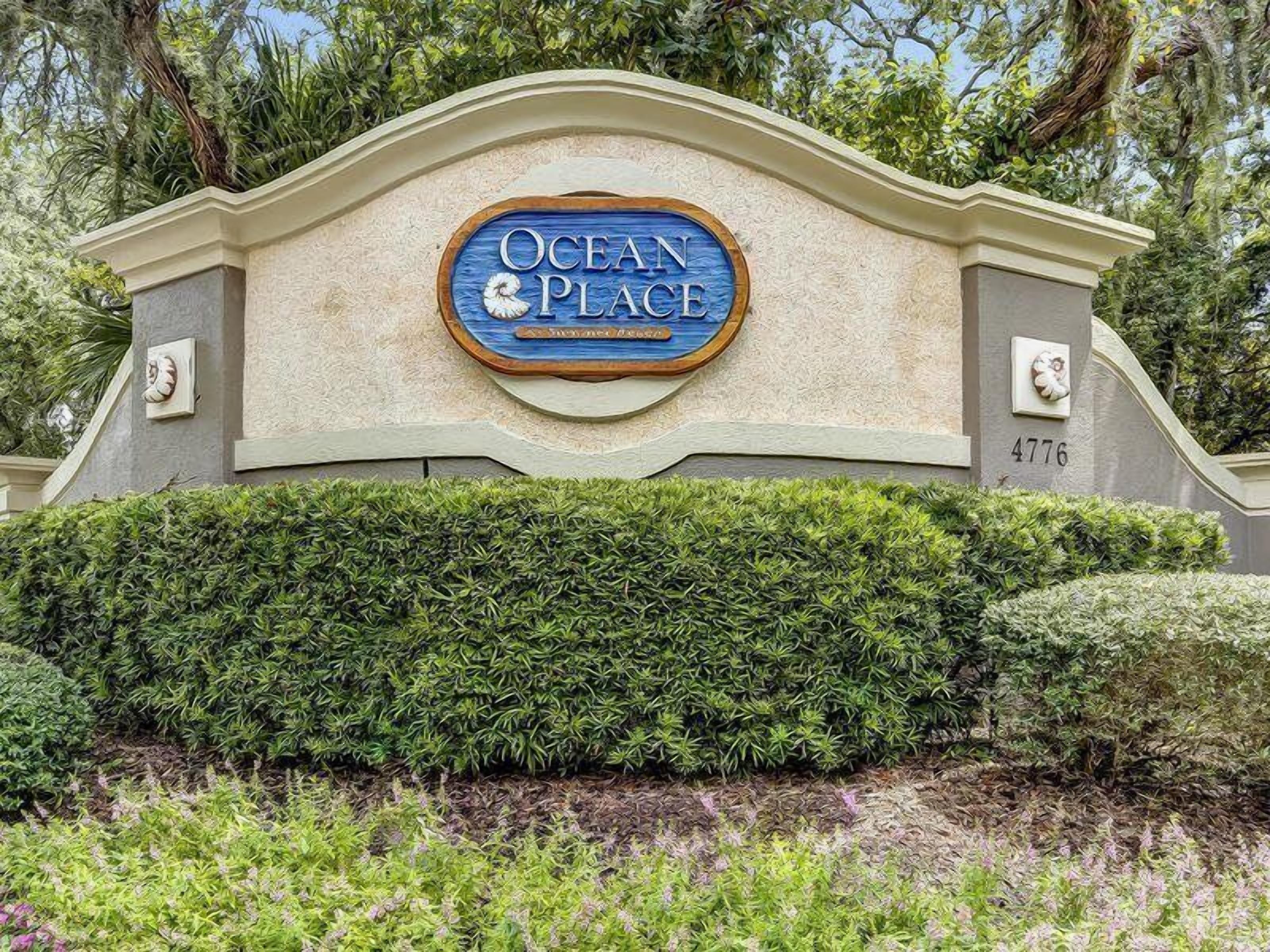 A sign for Ocean Place with a number 4776 on the wall.