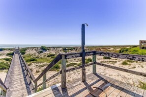 A wooden boardwalk leading to a beach with a clear view of the ocean. - 212-sailmaker (Fernandina Beach)