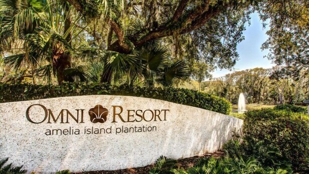 A sign for Omni Resort Amelia Island Plantation with lush greenery and a fountain in the background. - 2126 Beachwood (Fernandina Beach)