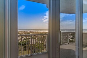 A balcony with a view of a beach and ocean. - 13-ocean-place (Fernandina Beach)