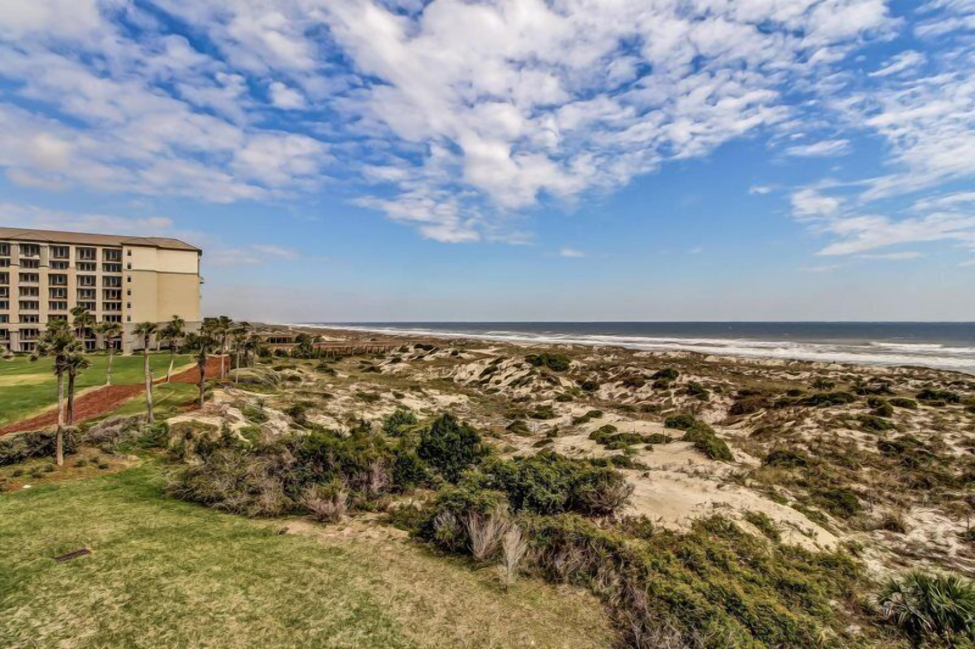 A coastal hotel with a view of the beach and ocean.