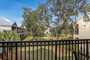 A residential area with a house, a tree, and a fence.