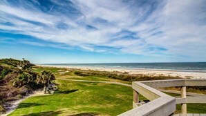 A coastal view from a wooden deck overlooking a beach and ocean. - 1109-beach-walker (Fernandina Beach)