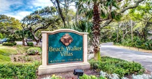 A sign for Beach Walker Villas with directional arrows and phone numbers. - 1109-beach-walker (Fernandina Beach)