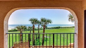 A balcony with a view of the ocean and palm trees. - 1825-turtle-dunes (Fernandina Beach)