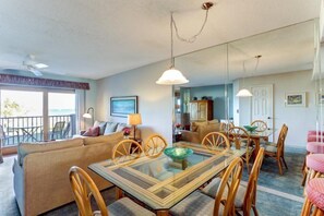 Relax in the spacious living area with a large glass-top table and comfortable sofa.