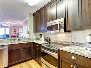 Condo | Private kitchen | Oven, stovetop, dishwasher, cookware/dishes/utensils - 4-ocean-place (Fernandina Beach)