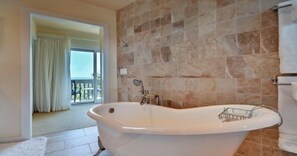 A bathroom with a freestanding bathtub, a shower, and a toilet.