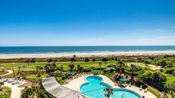A resort with a large pool, a beach view, and a golf course. - 1340-shipwatch (Fernandina Beach)