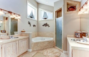 A modern bathroom with a large vanity, a freestanding bathtub, and a shower area. - 1060-s-fletcher-ave (Fernandina Beach)