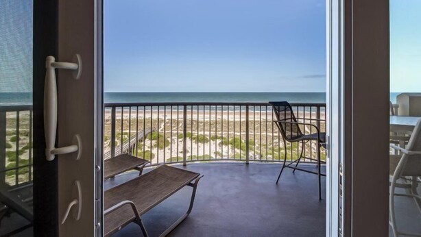 A balcony with a view of the beach and ocean. - 57-ocean-place (Fernandina Beach)