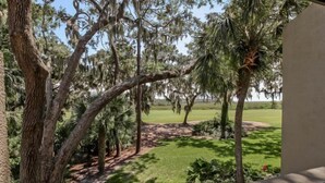A view of a landscaped area with trees and a lawn.