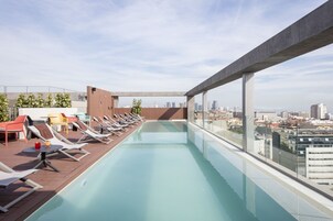 Una piscina al aire libre de temporada, sillones reclinables de piscina
