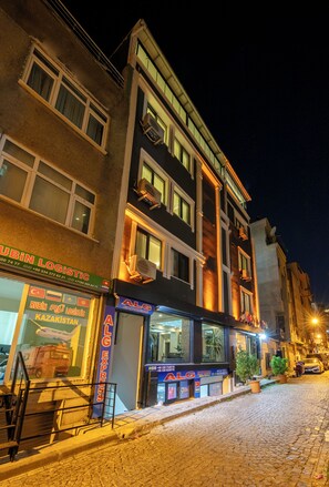 A multi-story building with a ground-level retail space and upper residential or office units. - Gul Otel (Istanbul)