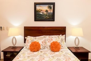 Relax in a serene space with a large bed, two nightstands, and a framed painting above.