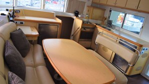 A compact kitchenette with a stove, sink, and small refrigerator. - Catamaran Lagoon by Veleros Colombia (Cartagena)