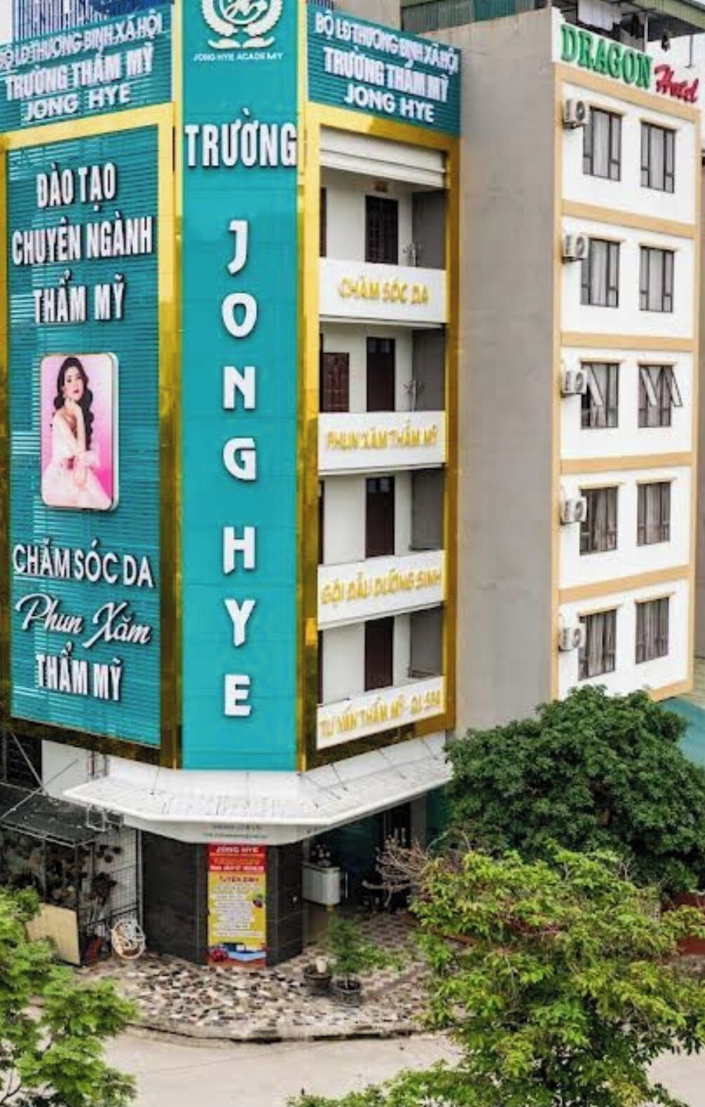 A building with multiple signs, including one for 'Dragon Hotel' and another for 'Truong Thanh My'.