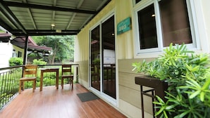 A covered outdoor area with a wooden table and chairs, a green sign with the number 503, and a potted plant. - Samba Bluewater Resort (Olongapo)