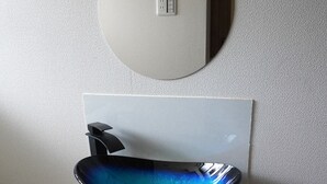 A bathroom with a white sink, a round mirror, and a lace curtain. - Guest House Ioly Osaka - Hostel (Fujiidera)