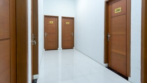 A hallway with three wooden doors, each marked with a number.