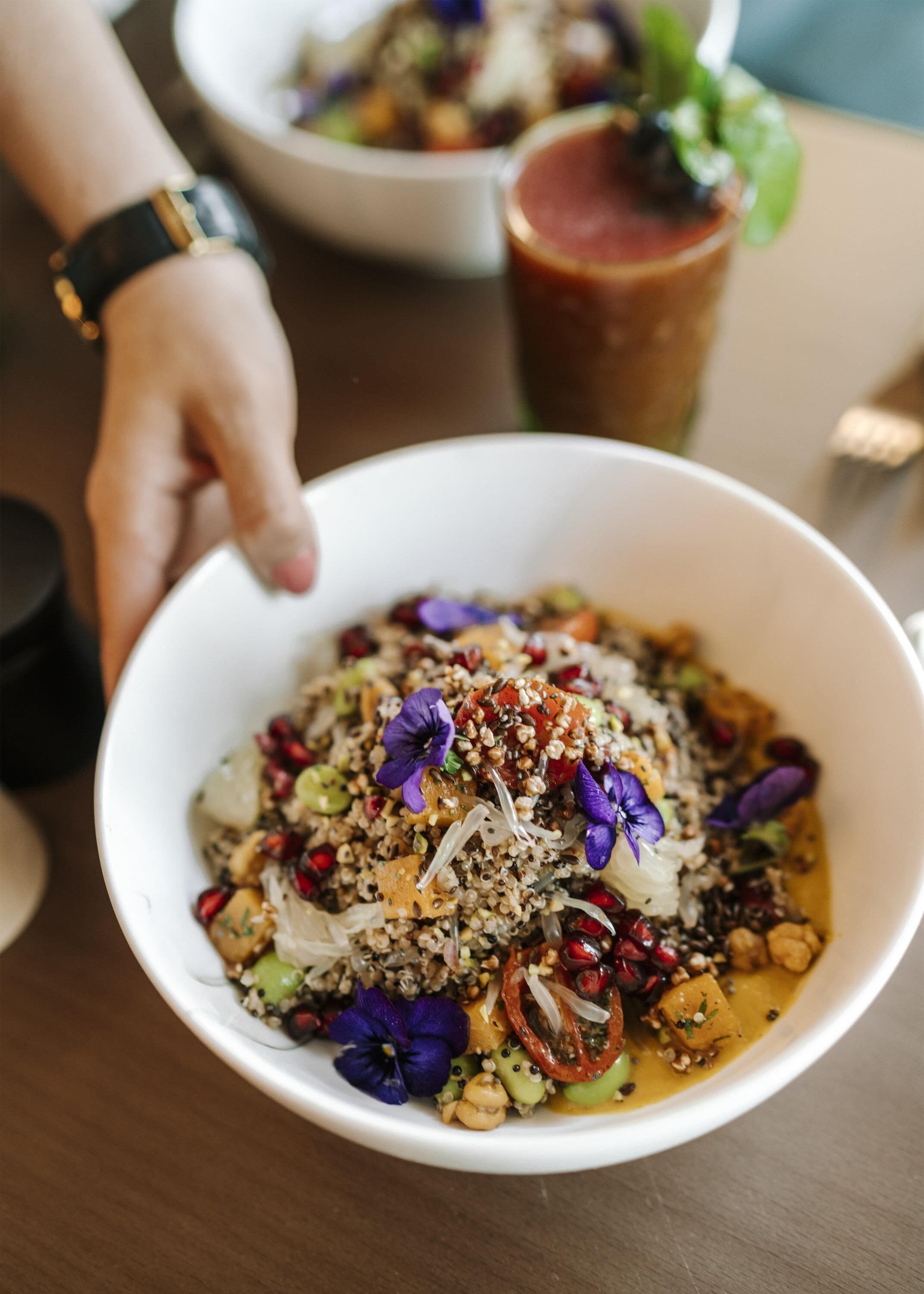 A bowl of food with various ingredients and garnishes.
