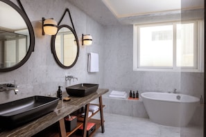 Enjoy a relaxing soak in the bathtub or freshen up at the sleek sink with ample lighting.