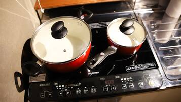 An electric stove with two pots on it.