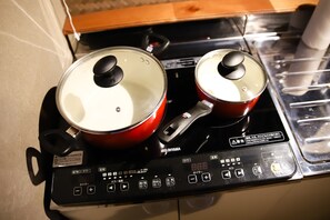 An electric stove with two pots on it.
