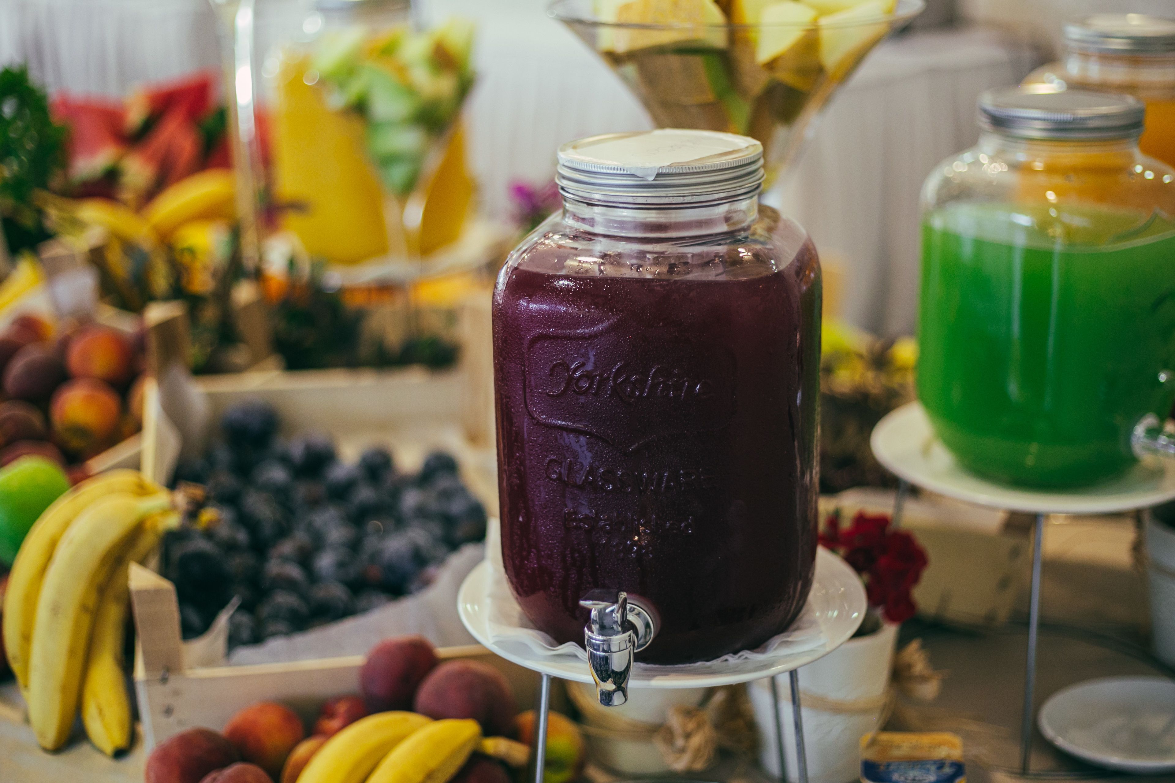 A beverage station with a large jar labeled 'Gala' and a green drink in the background.