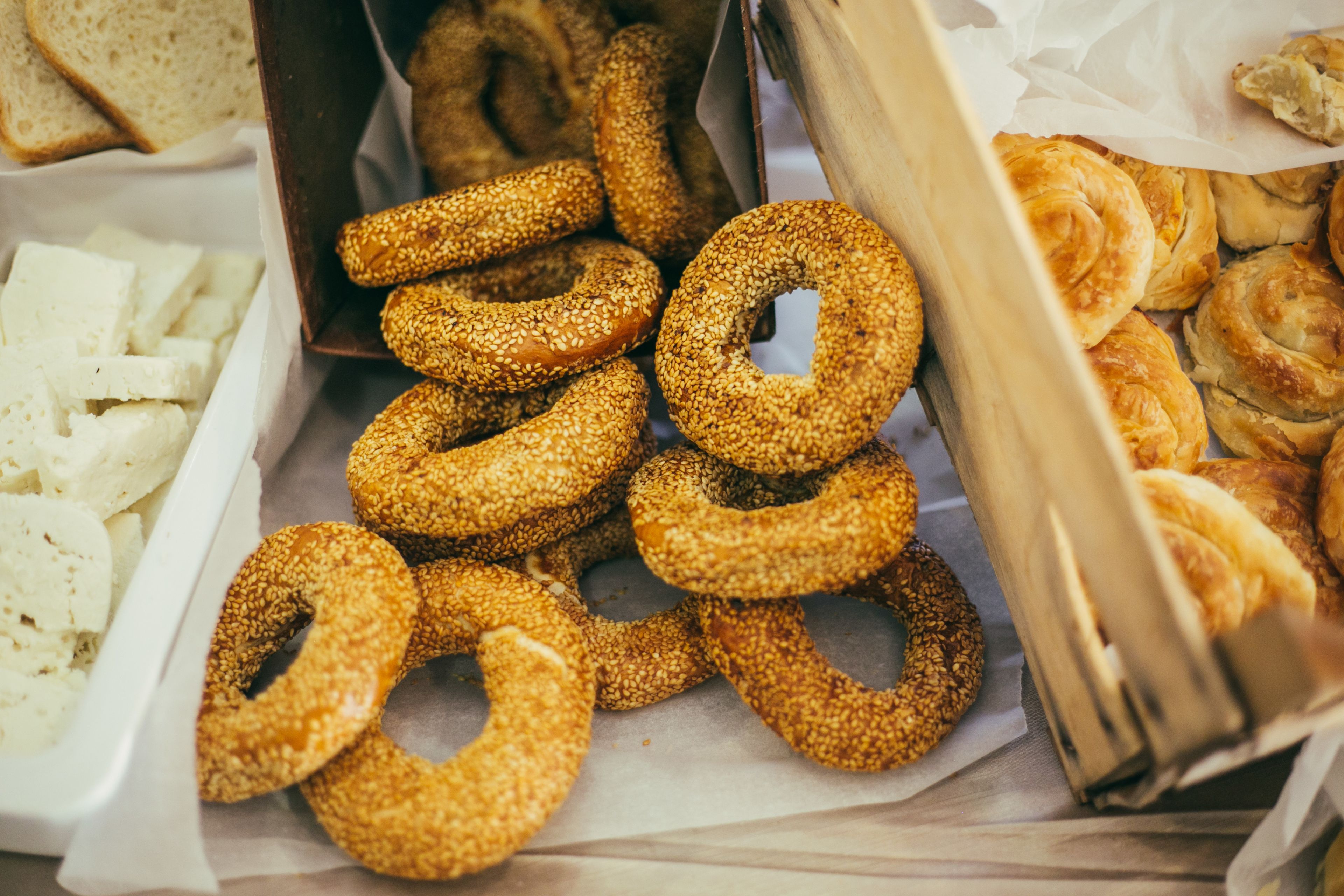 Diverse gebakken producten, waaronder sesamringetjes en croissants.