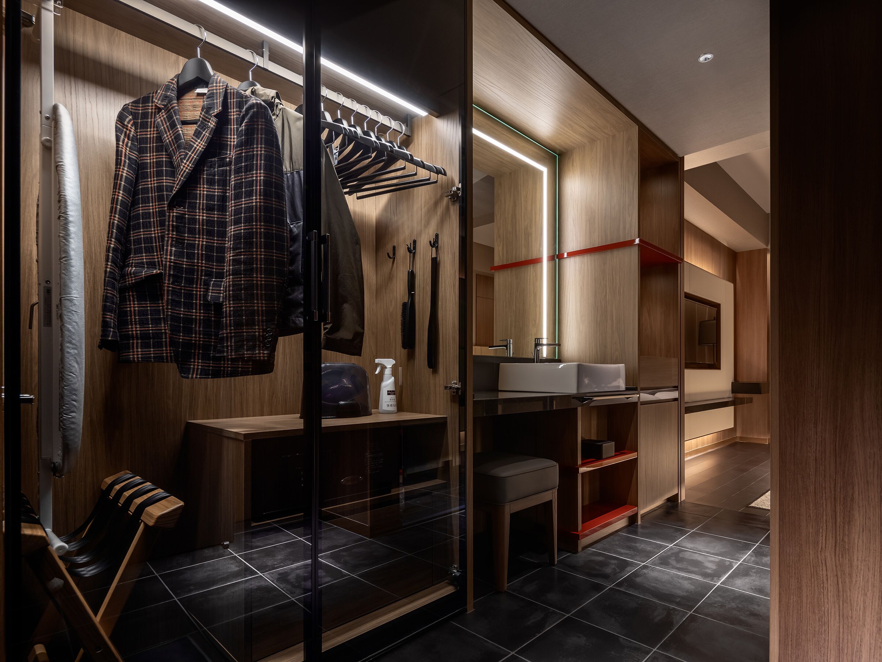 A modern bathroom with a glass shower enclosure, a wooden vanity, and a mirror above the sink.