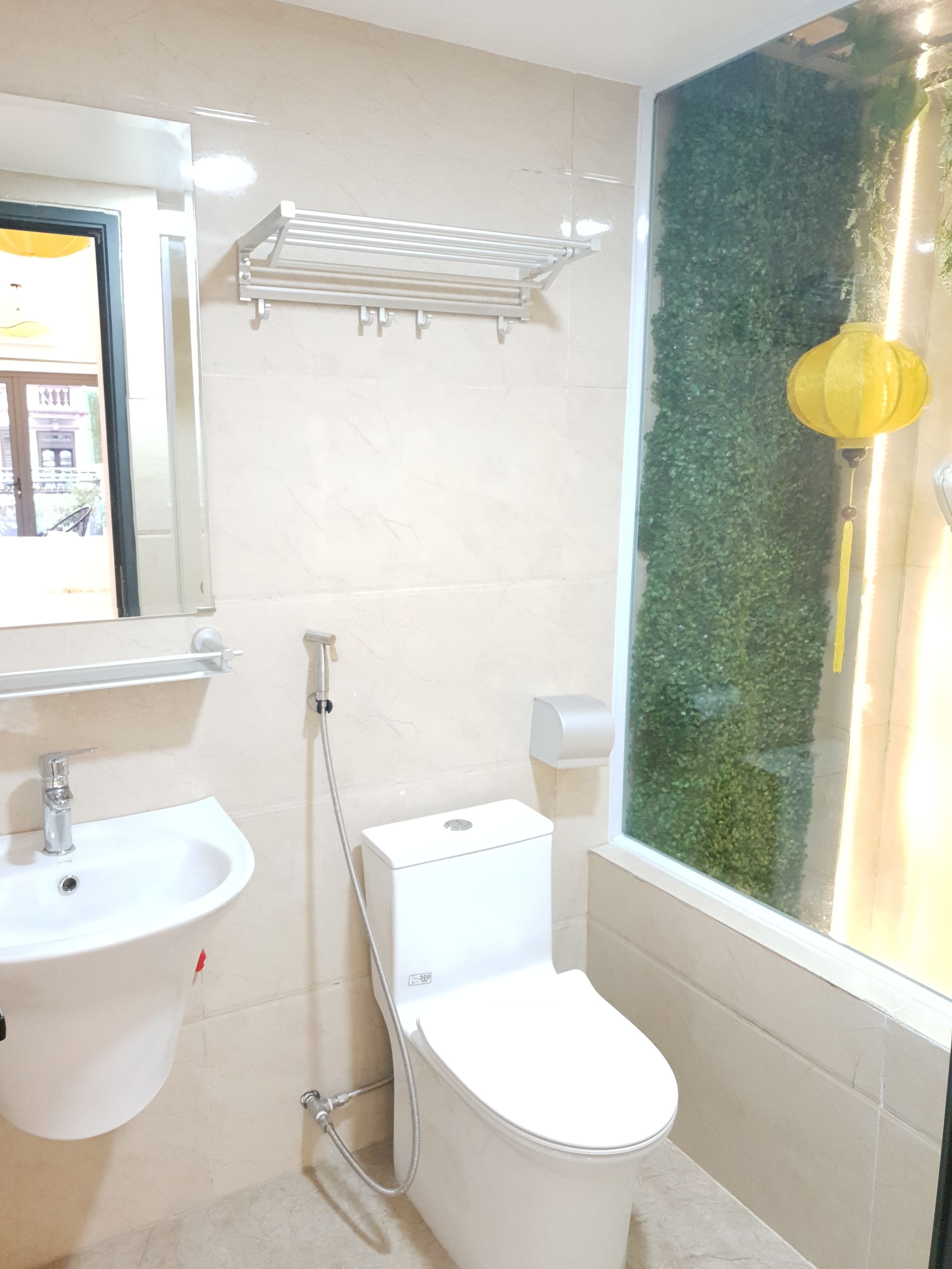 A bathroom with a toilet, sink, and shower.