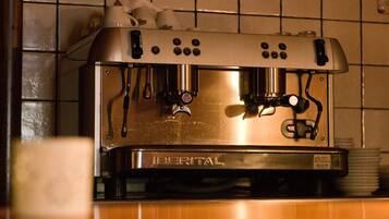 A coffee machine with a digital display and multiple control buttons.