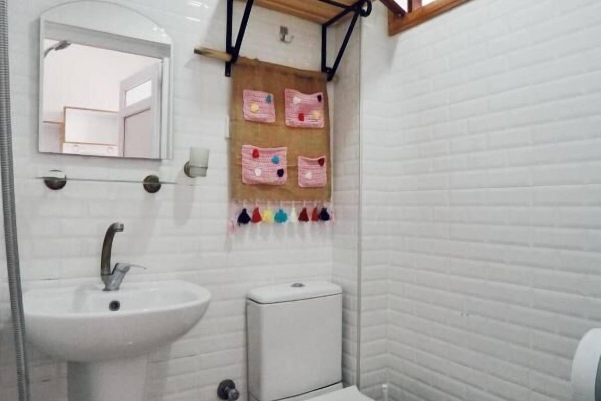 shower, hair dryer, slippers, towels