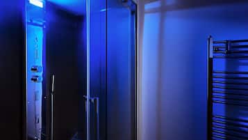 A modern elevator with a control panel and a glass door.