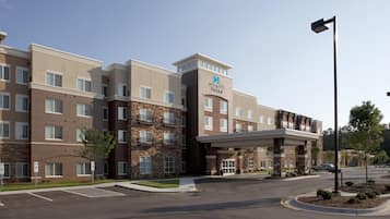 A multi-story hotel with a stone facade, a prominent 'Hyatt House' sign, and a covered entrance.