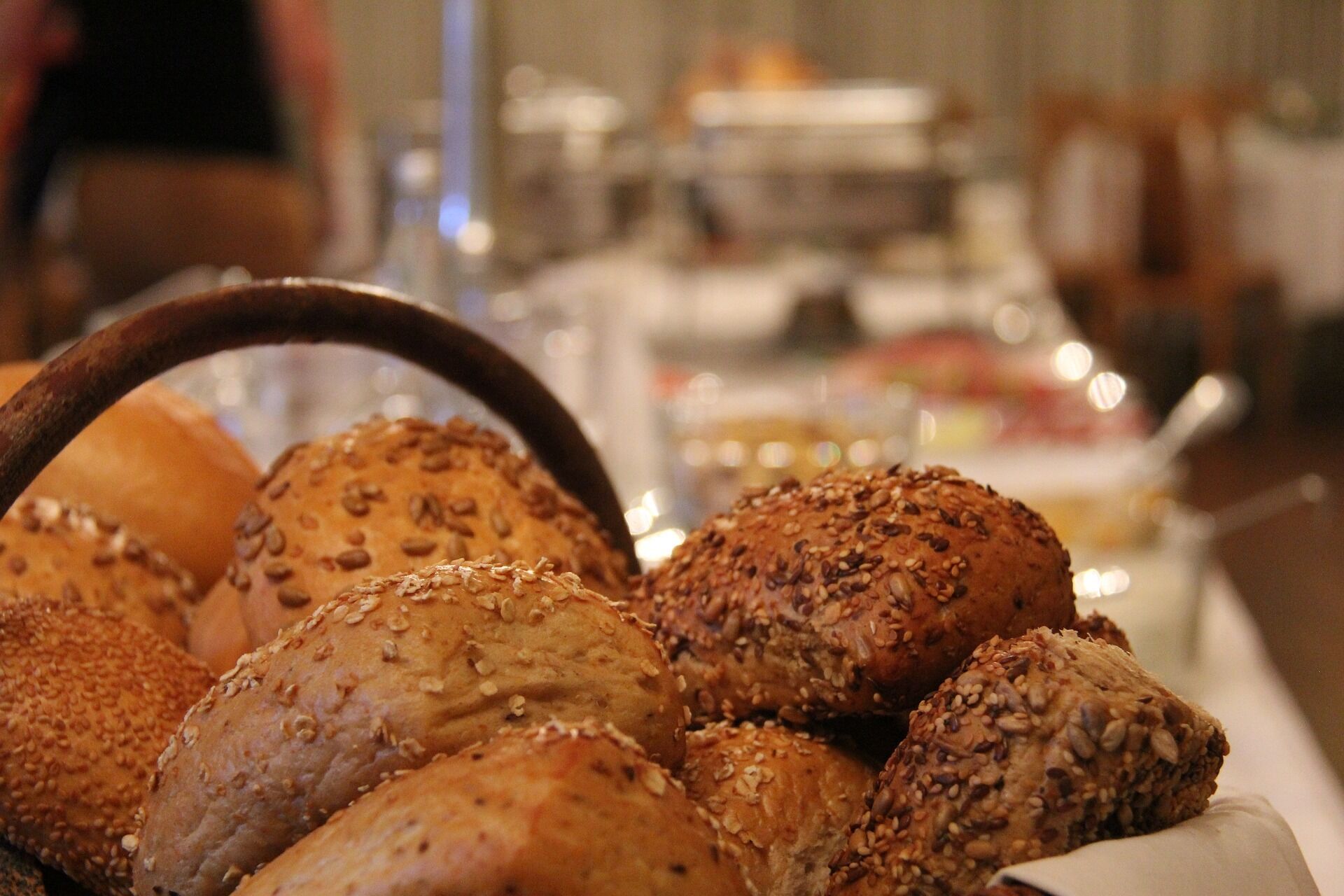 A variety of breads with seeds on a table.