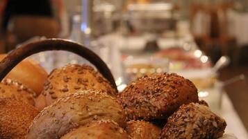 A variety of breads with seeds on a table.