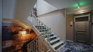 A staircase with ornate white railings and a mural of a historic building. - W Regal Boutique&Spa (Constanta)