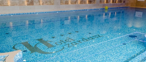 Indoor pool, open 4:00 PM to 9:00 PM, pool loungers