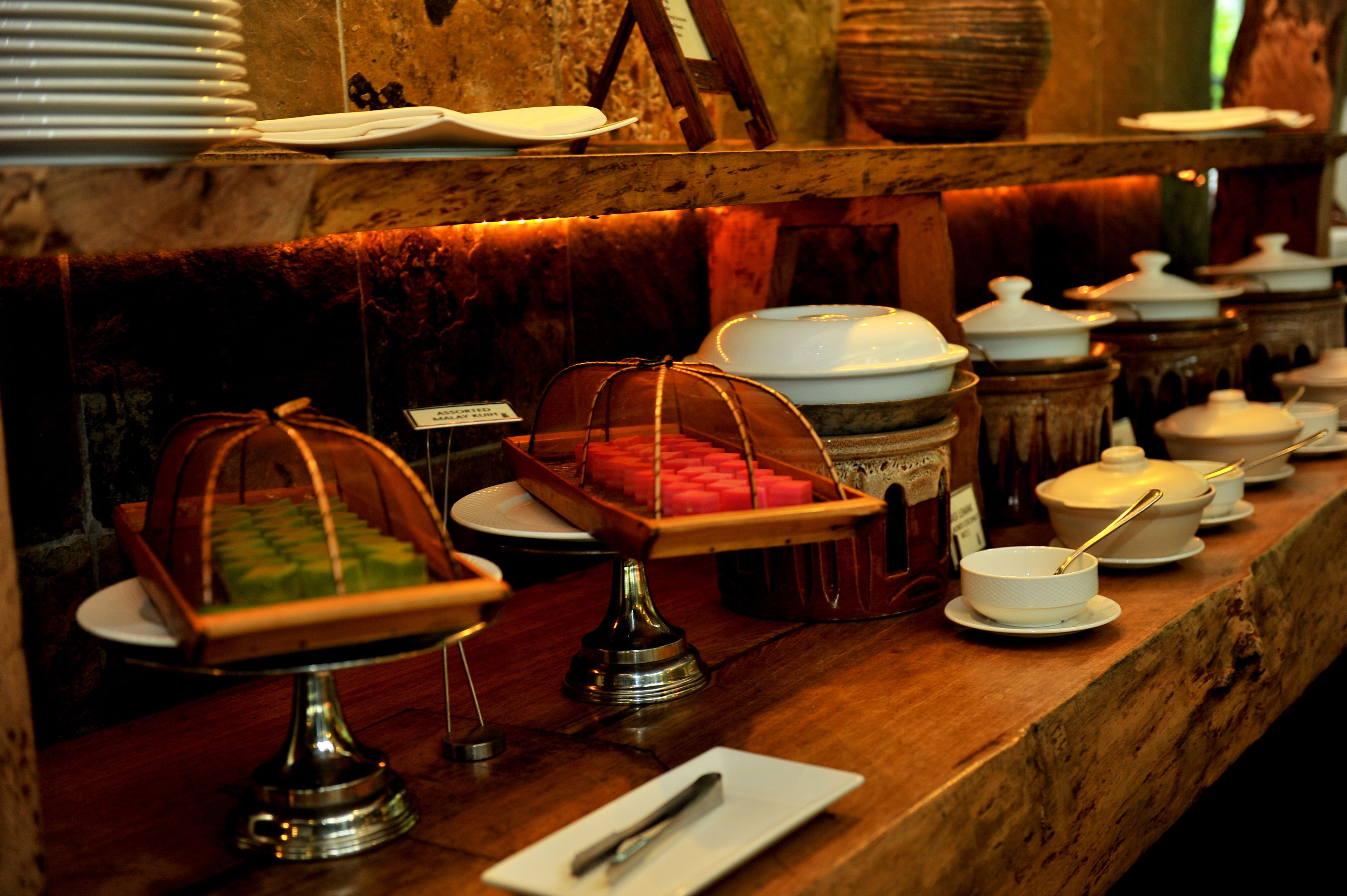 A buffet setup with various food containers and serving dishes.