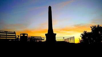 A monument silhouette against a sunset sky.