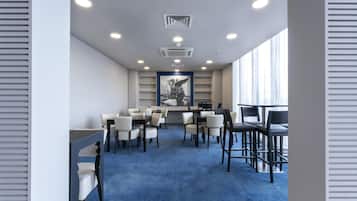 A conference room with a blue carpet, white walls, and a large window.