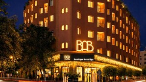 A multi-story hotel with a prominent 'B&B' sign, a boutique hotel spa, and a well-lit facade. - Bab Hotel (Marrakech)