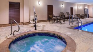 A hotel pool area with a hot tub, lounge chairs, and a dining area. - Hampton Inn & Suites Big Spring (Big Spring)