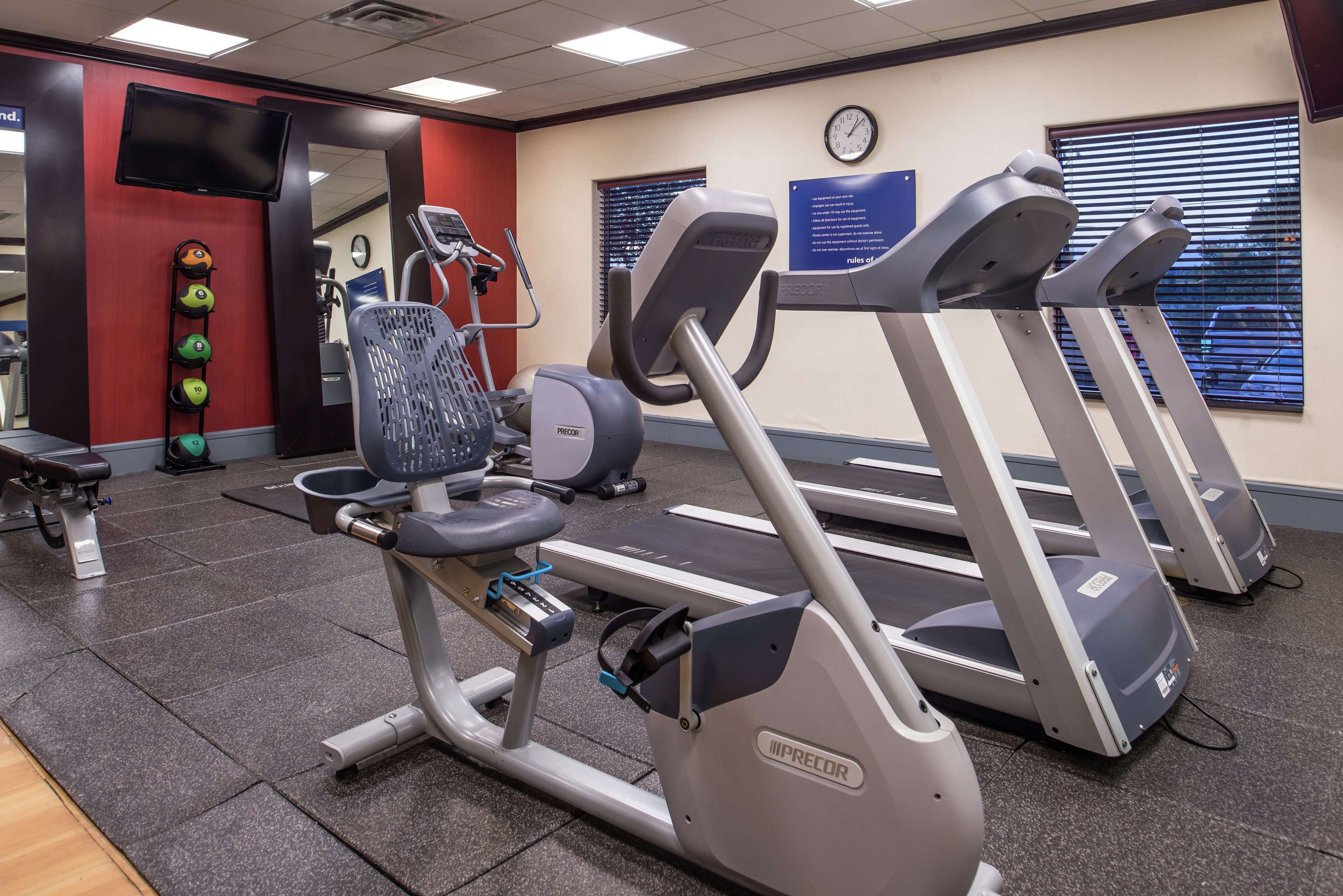 A gym with treadmills, stationary bikes, and weight machines.