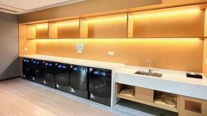 A modern kitchen with built-in appliances, a sink, and storage cabinets. - Dihao Hotel (Quanzhou)