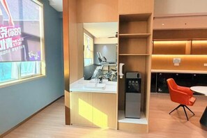 A modern kitchen with a built-in espresso machine, a sink, and a countertop. - Dihao Hotel (Quanzhou)