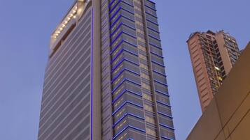 A tall building with a prominent sign at the top.